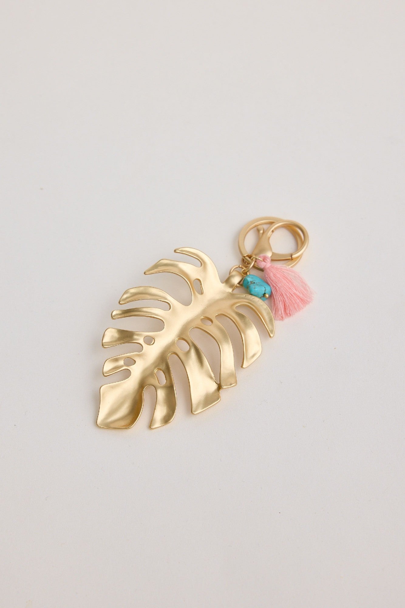 Holiday Leaf Key Ring in Brushed Gold with blue stone & tassle